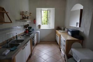 a kitchen with a sink and a window at Manoir de la Guerrie in Saint-Patrice-de-Claids