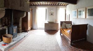 a living room with a fireplace and a bed in it at Manoir de la Guerrie in Saint-Patrice-de-Claids