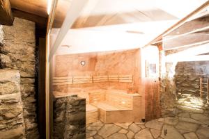 a sauna in a house with a stone wall at Hof Alpenjuwel in Nauders