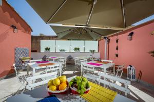 a patio with tables and chairs with fruit on them at Antico Canale in Castellammare del Golfo +32 photos