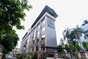 a building with a sign on the side of it at Central Courtyard Boutique Hotel in Siliguri