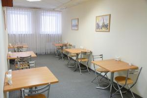 an empty classroom with tables and chairs in it at Taganskaya Hotel in Yekaterinburg