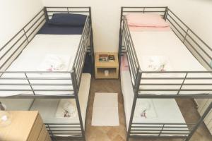 a trio of bunk beds in a room at Villa Pomelia in Balestrate