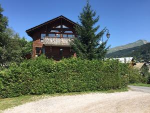 a house with a balcony on the side of a road at Apartements Le Bourg du Jean in Morzine