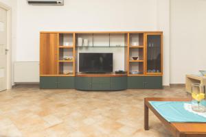 a living room with a entertainment center with a flat screen tv at Villa Pomelia in Balestrate