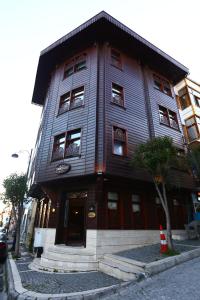 a large wooden building on the corner of a street at Emine Sultan Hotel in Istanbul