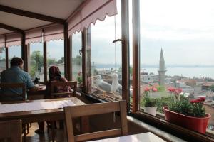 a couple sitting at a restaurant looking out at the city at Emine Sultan Hotel in Istanbul