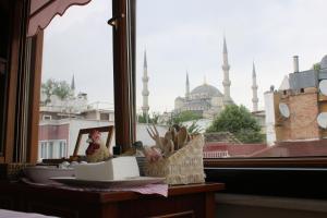 a table with a window with a view of the blue mosque at Emine Sultan Hotel in Istanbul