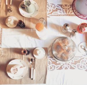 a table with plates and dishes on top of it at B&B Da Zia Ore in Iesi