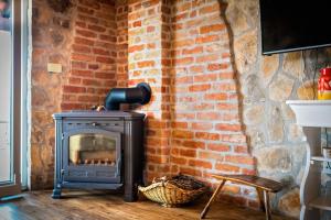 a brick wall with a stove in a room at Holiday Home Vlatka in Lozovac
