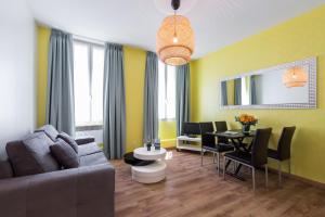 a living room with a couch and a table at Florella Clemenceau Apartment in Cannes