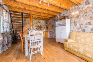 a kitchen and living room with a table and a couch at Holiday Home Vlatka in Lozovac