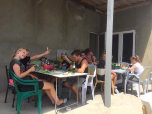 a group of people sitting at tables in a restaurant at Why Me Eco-friendly Hostel in Tbilisi City