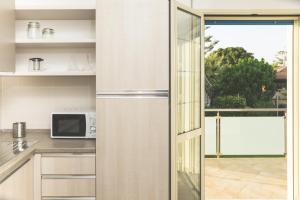 a kitchen with a door open to a balcony at Villa Pomelia in Balestrate