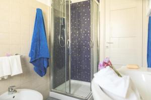 a bathroom with a shower and a toilet and a sink at Villa Pomelia in Balestrate +16 photos