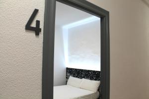 a mirror hanging on a wall with a white couch at Alevia in Salamanca