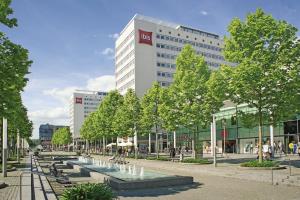 a large building with a lot of trees in front of it at ibis Dresden Zentrum in Dresden