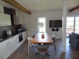 a kitchen and dining room with a wooden table at Landliebe in Hasselberg