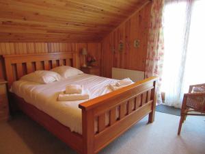 スイヤックにあるNice chalet in the woods of the beautiful Dordogneのベッドルーム1室(ベッド1台、タオル2枚付)