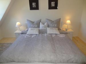 a bedroom with a large bed with pillows at Landliebe in Hasselberg