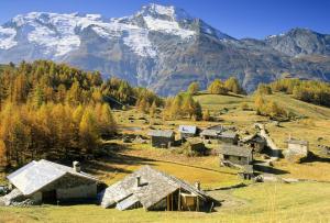 an old village with mountains in the background at Arpege Des Neiges in Sainte-Foy-Tarentaise