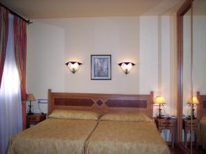 A bed or beds in a room at Castillo Lanjaron