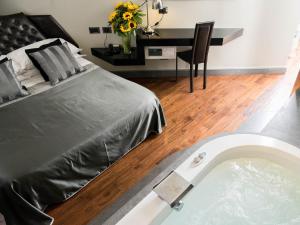 a bedroom with a bed and a bath tub at Le Stanze Di Federica in Rome