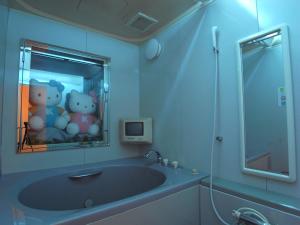 a bathroom with a tub with teddy bears in the mirror at Hotel Chocola Gose (Adult Only) in Gose
