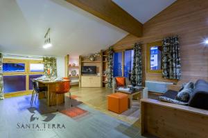 a living room filled with furniture and a fireplace at Résidence Santa Terra in Tignes