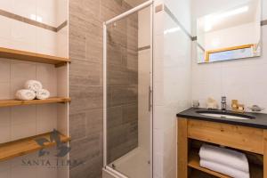 a bathroom with a sink, toilet and shower stall at Résidence Santa Terra in Tignes