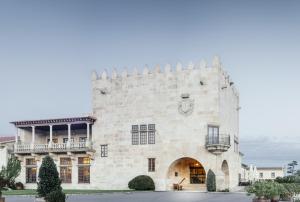 a large building with a clock on the front of it at Parador de Baiona in Baiona