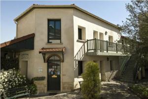 a large house with a porch and a balcony at Résidence Chlorophylle in Arcueil