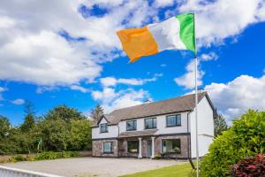 a flag in front of a house at Lios Na Manach ECO B&B in Killarney
