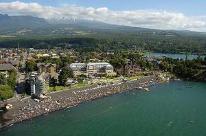 an aerial view of a city and a body of water at Departamento Pucón in Pucón