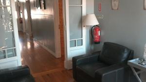 a living room with a fire hydrant next to a chair at Casa Azul Hostel in Sintra