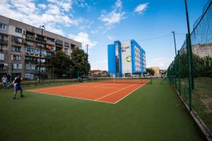 two people playing tennis on a tennis court at Court Inn in Panagyurishte