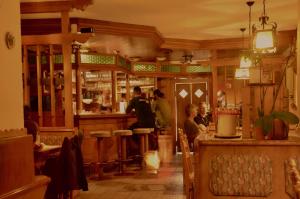 a restaurant with people sitting at a bar at Locus Malontina Hotel in Gmünd in Kärnten