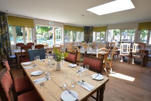 a dining room with a large wooden table and chairs at The Dolphin Inn in Thorpeness