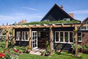an extension to a house with a pergola at The Dolphin Inn in Thorpeness