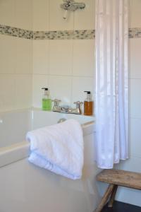 a bathroom with a bath tub and a towel at The Dolphin Inn in Thorpeness