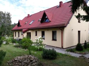 a house with a red roof at Apartamenty Kama in Polanica-Zdrój