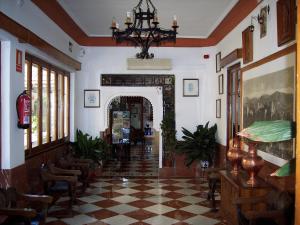 a hallway with a room with a checkered floor at Castillo Lanjaron in Lanjarón