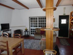a living room with a table and a fireplace at Apartamento Bela Vista in Pereira