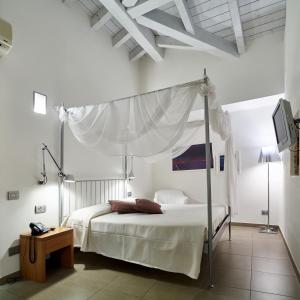Säng eller sängar i ett rum på San Rocco Hotel