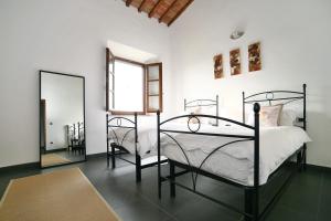 a bedroom with two beds and a mirror at Luxury Villa in Grassina