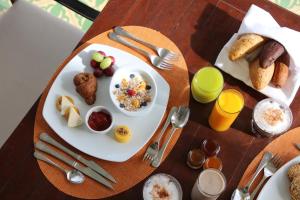 a table with a plate of breakfast food on it at Iberostar Grand Bavaro Hotel in Punta Cana
