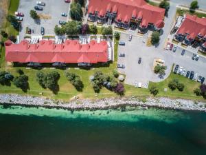 an aerial view of a building with red roofs next to the water at Riverside by FantasticStay in Fernie
