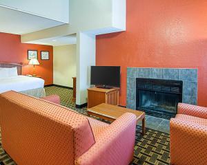 a hotel room with a bed and a fireplace at Extended Studio Suites Hotel- Bossier City in Bossier City