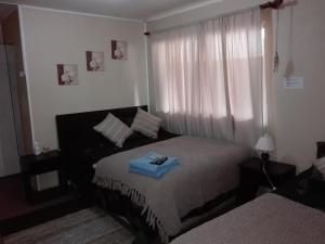 Ein Bett oder Betten in einem Zimmer der Unterkunft Hostal Los Guindos