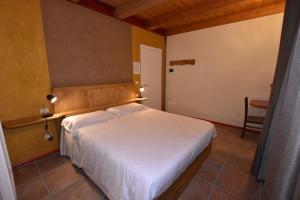 מיטה או מיטות בחדר ב-Alpuntogiusto